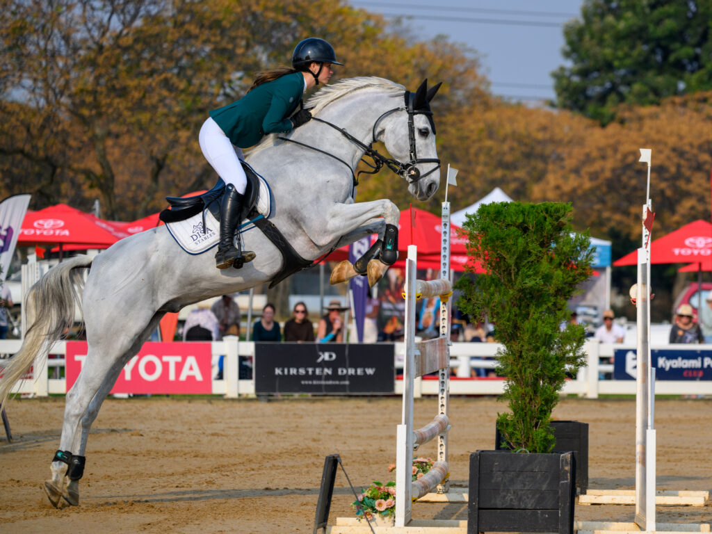 FLYING HIGH: South African national rider Amy Michau and her phenomenal Dutch Warmblood, Go To Blue, clearing a massive obstacle during the Toyota World Cup Qualifier at Kyalami Park. (Photo: Sport South Africa)